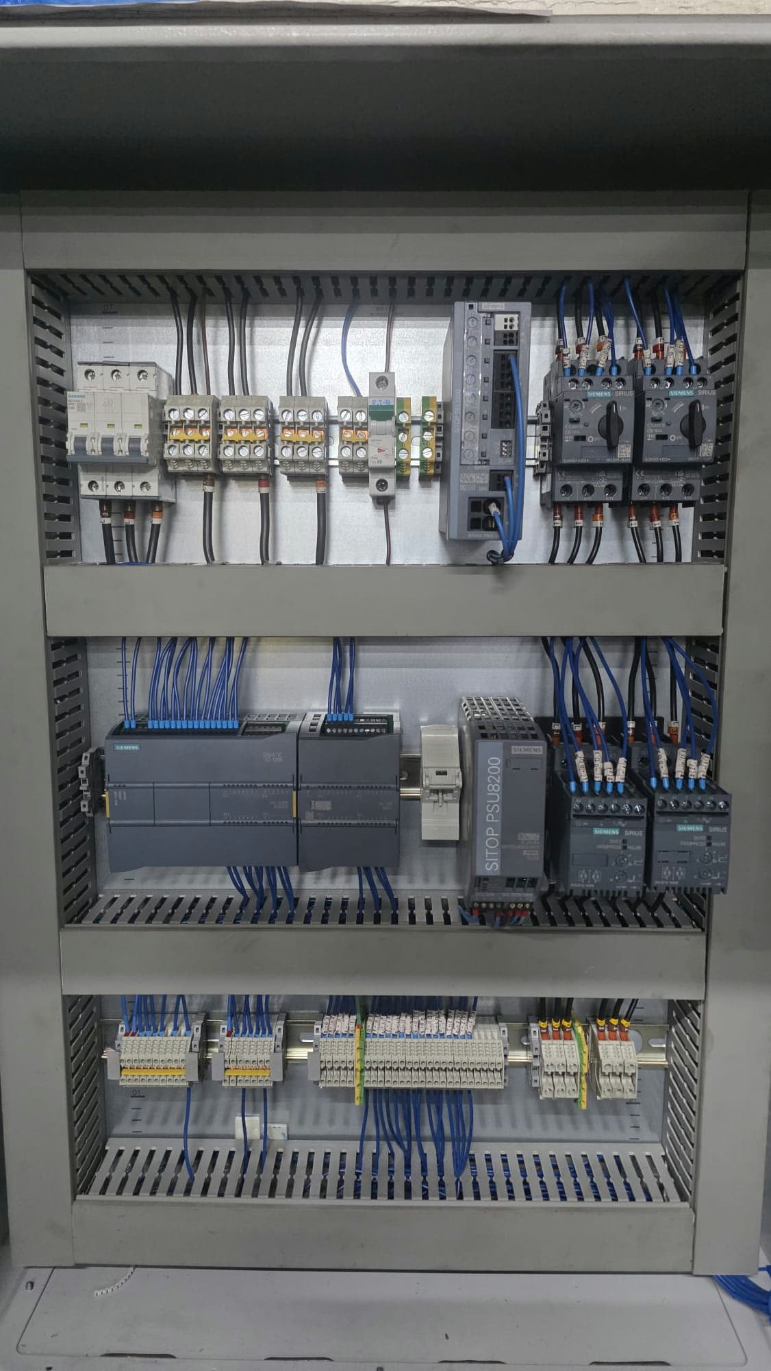 Pump control panel interior with a Siemens S7-1200, SITOP supply and SIRIUS soft starters